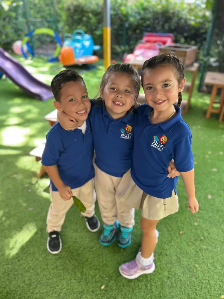 Three children smiling in the garden