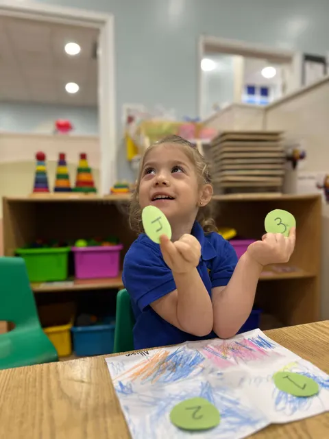A girl showing off her stamped artwork